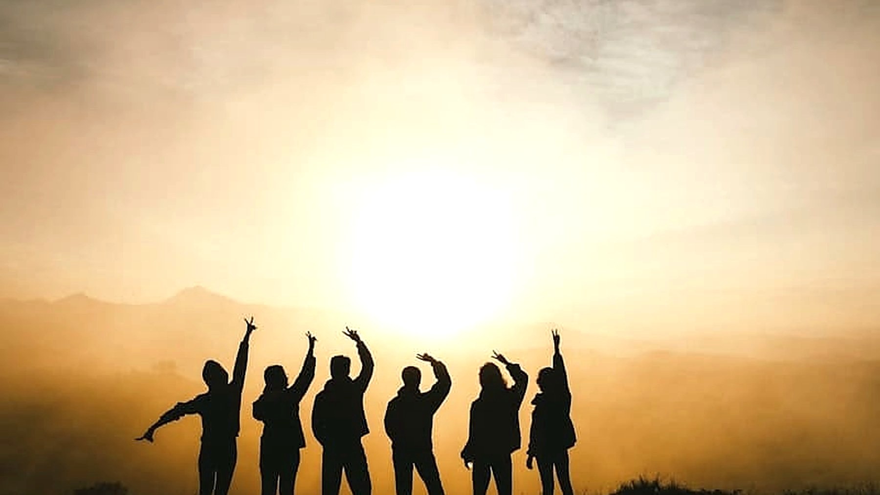 Travellers silhouetted at sunrise